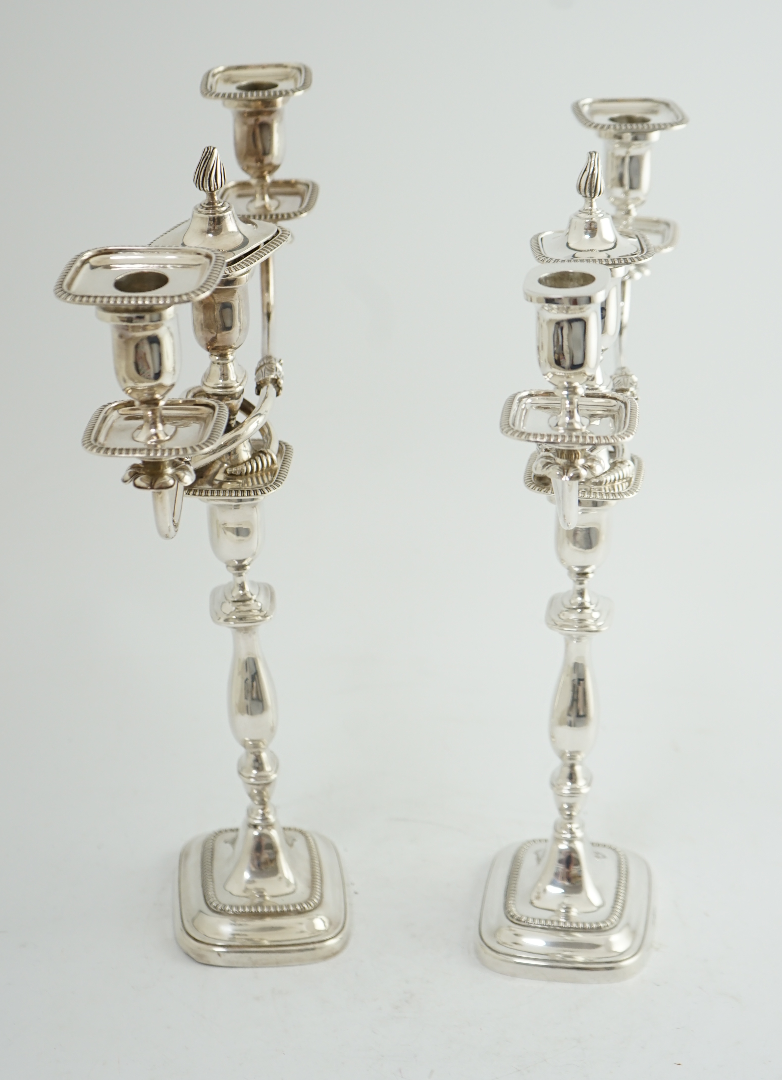 A pair of Elizabeth II silver two branch two light candelabra, by James Dixon & Sons